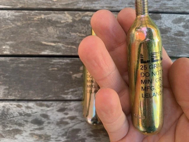 River Sports Store -River Sports Store HandshowingproportionsofaLeland25grCo2cartridgeforbigwavesurfingvests